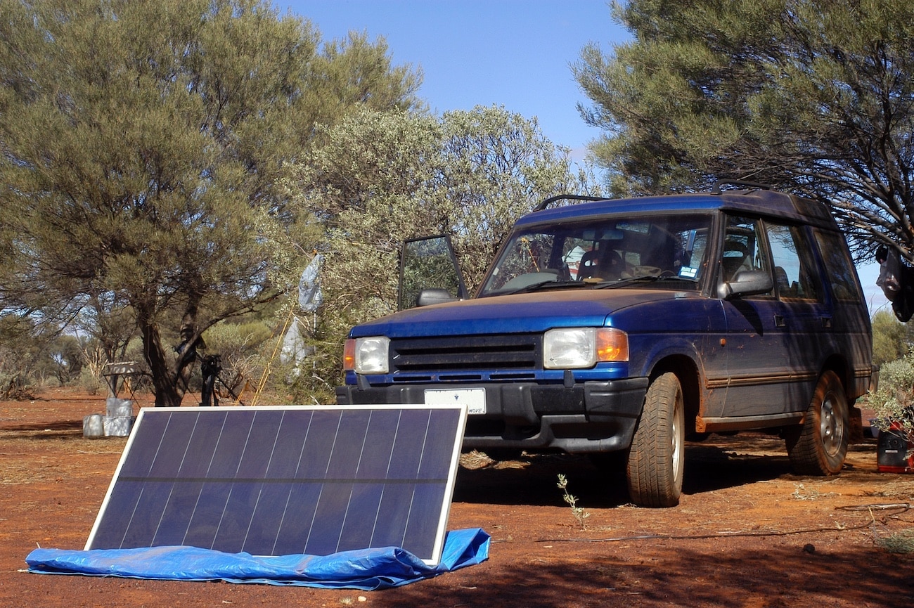 portable solar panel in front of car.