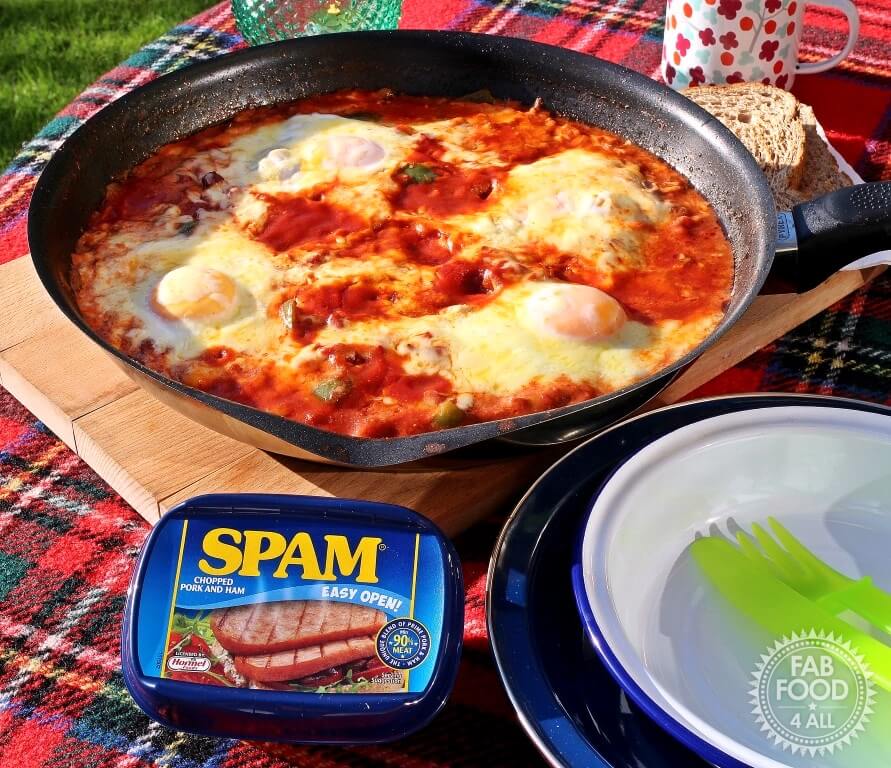 chilli spam and eggs in skillet with a tin of spam in the foreground.