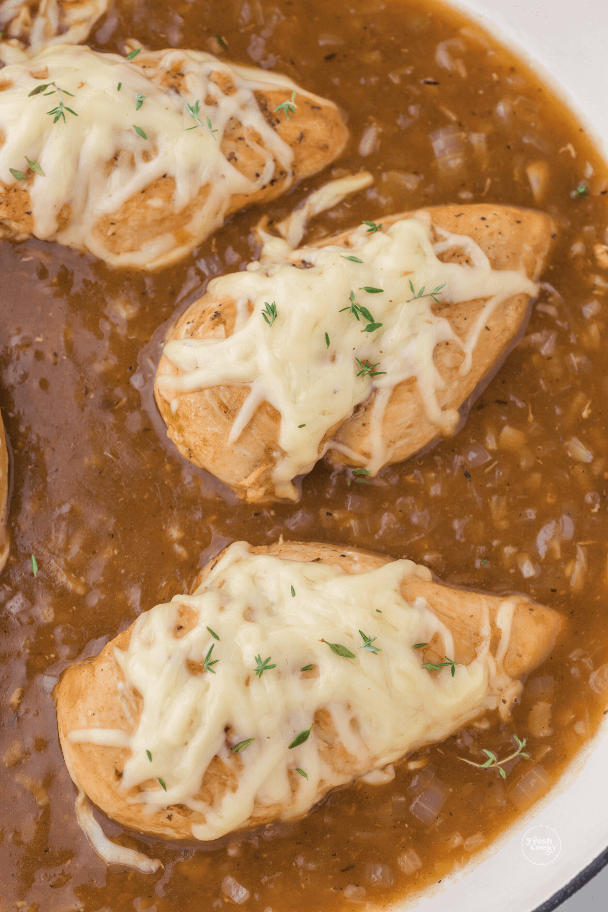 close up of french onion chicken breasts in stew.