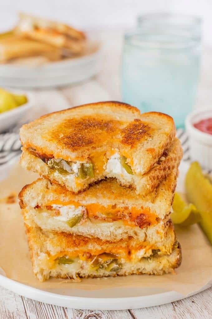 stack of popper grilled cheese sandwiches on a board.