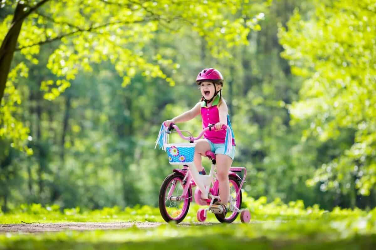child riding bike near campsite.