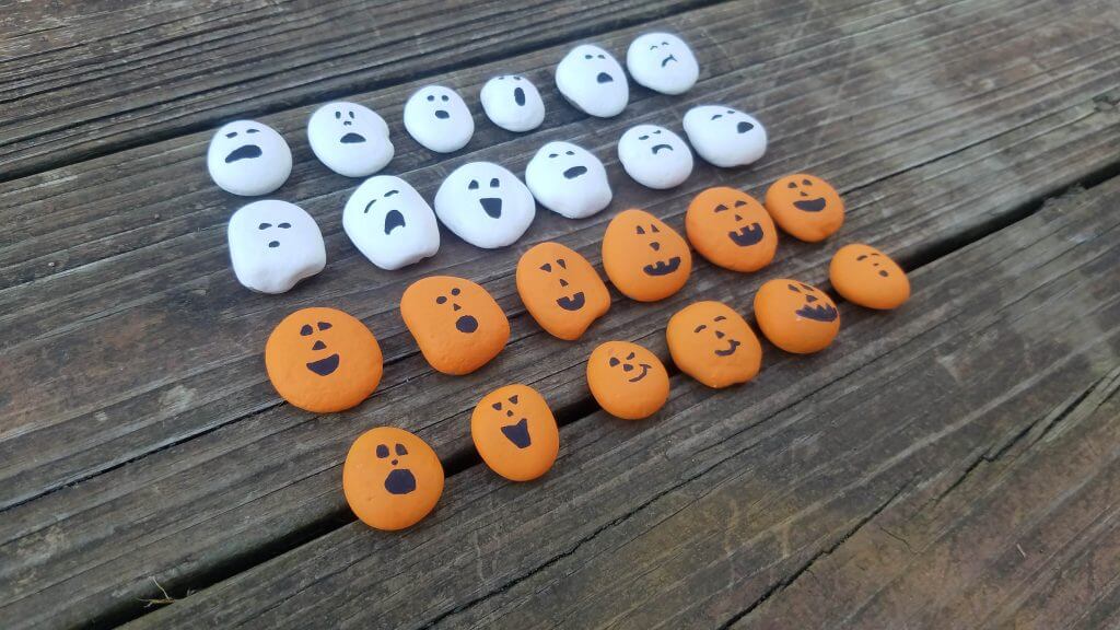 halloween themed orange and white rocks painted for a checkers set.