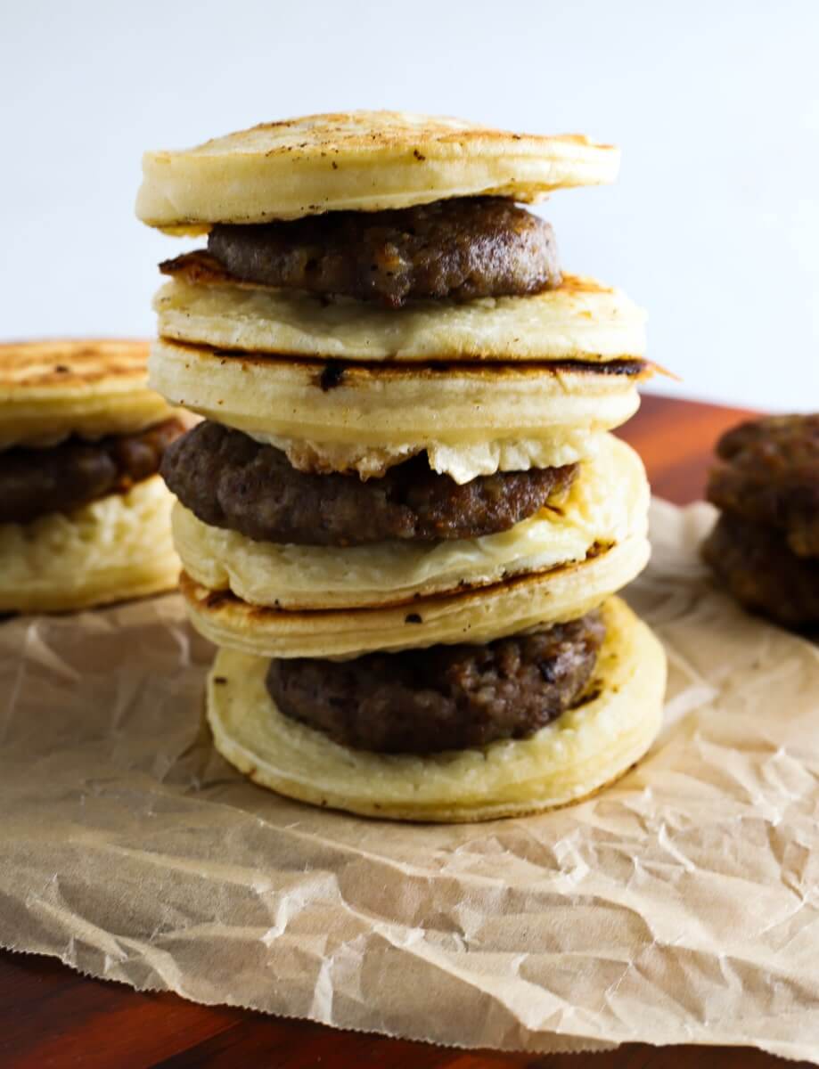 stack of pancake sausage mcgriddles on brown paper.