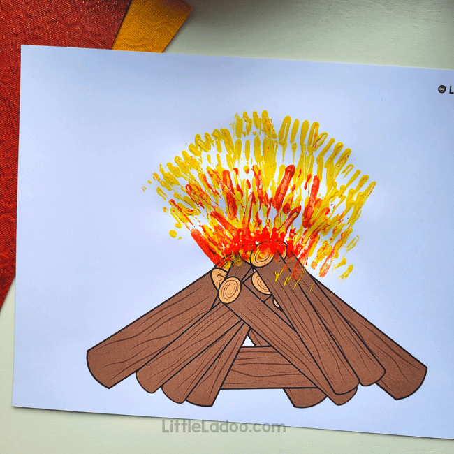 printed campfire picture with yellow and orange painted fire.