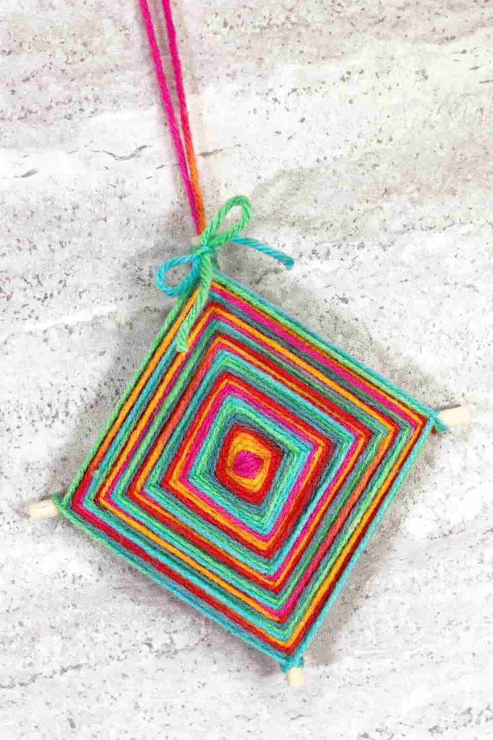 gods eye craft using colourful yarn.