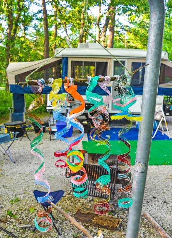 wind spirals made from recycled water bottles hanging at campsite.