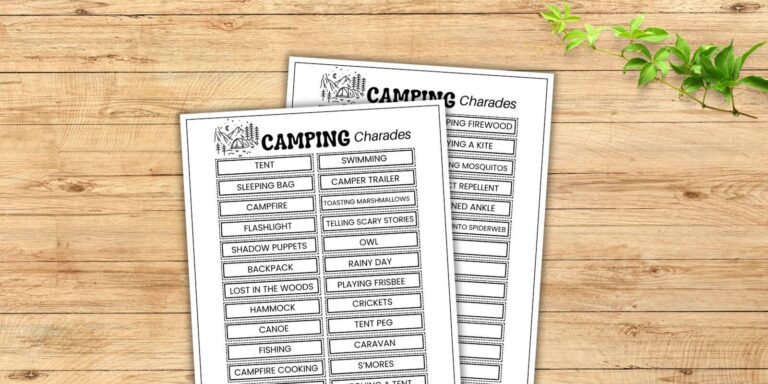 free printable camping charades list on wood table.