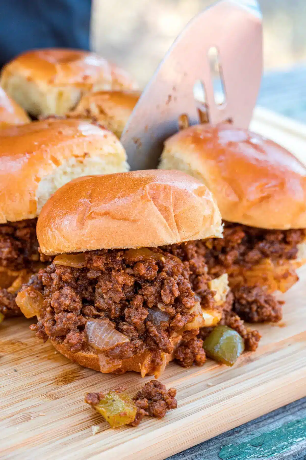 sloppy joes on a wooden board.