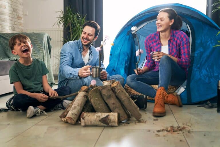 family having an indoor camping night in their living room.